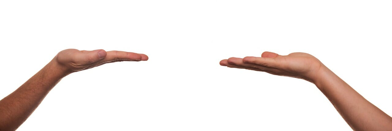 Two hands engaging in behavior therapy on a white background.