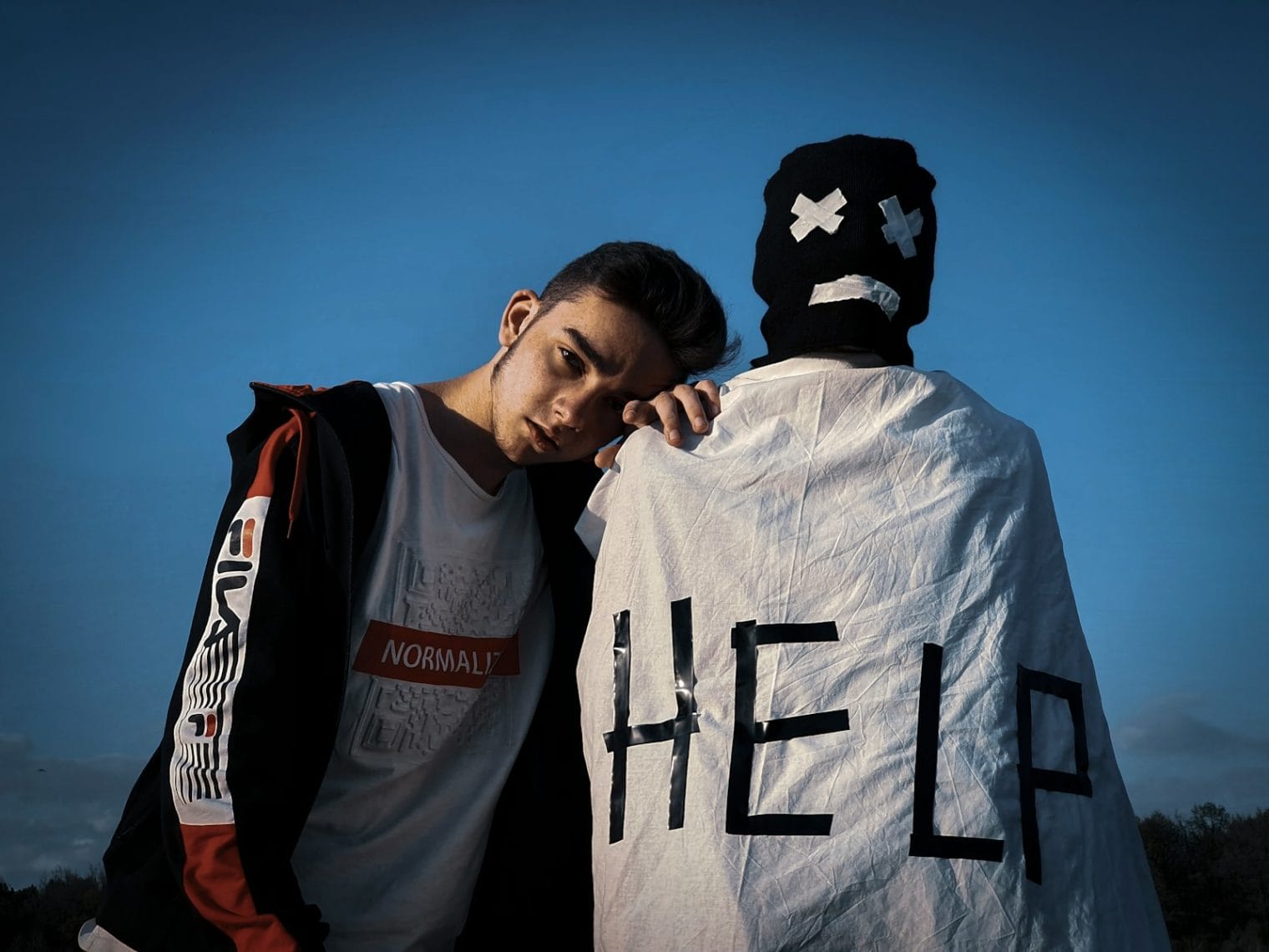 man in white and black jacket beside man in white and black crew neck shirt under